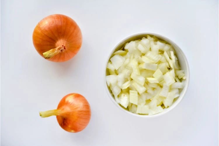 Oignon blanc et découpé à côté pour représenter les apports nutritionnels de celle-ci